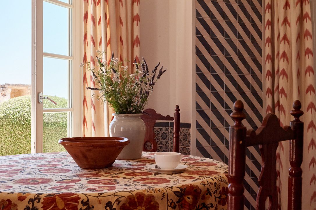 A breakfast table beside the open window