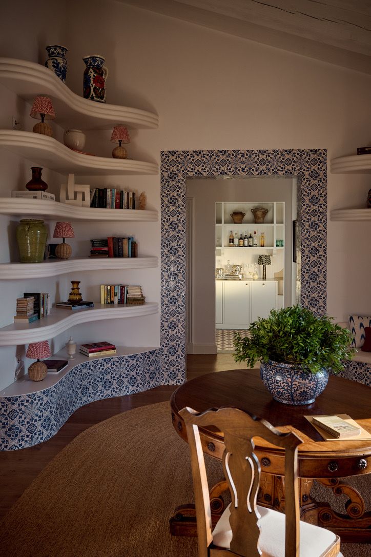 Curved shelves and blue-and-white tiles in the library