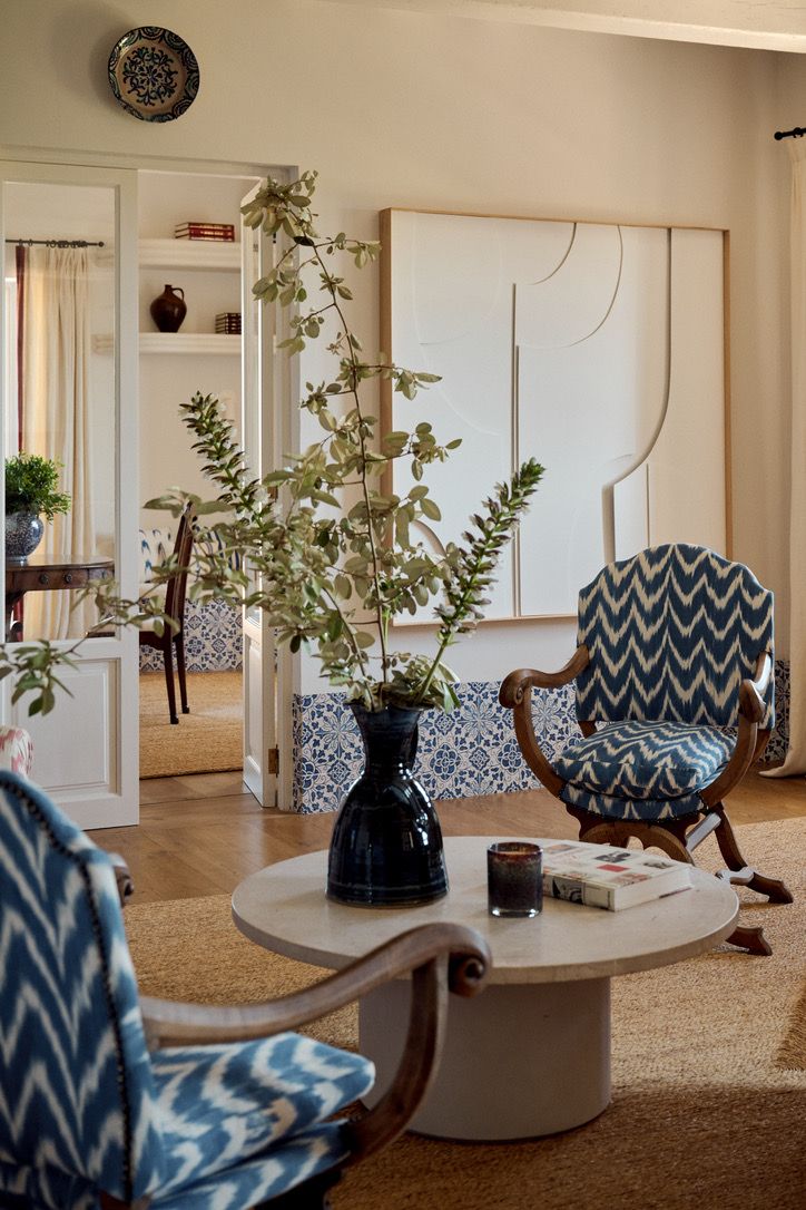 Ikat armchairs around a stone coffee table in the drawing room