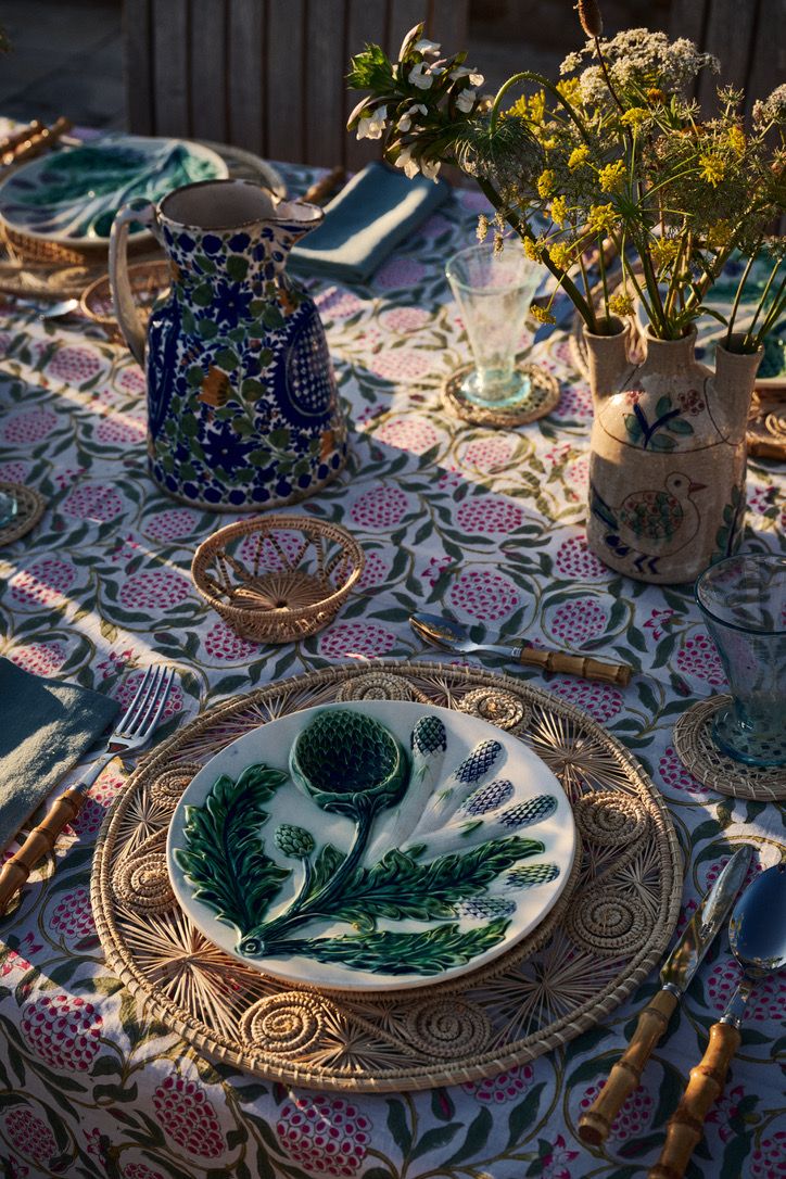 Majolica artichoke plates and painted jugs in the evening sun