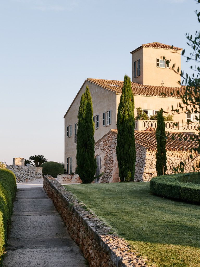 The house above the walled path, cypresses at the door